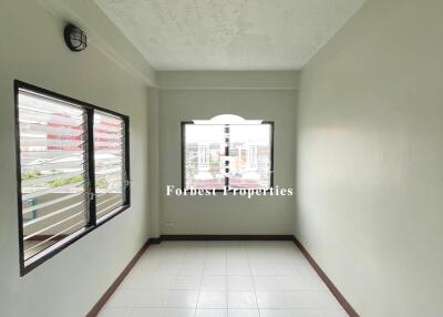 Narrow Room with Tiled Floor and Windows