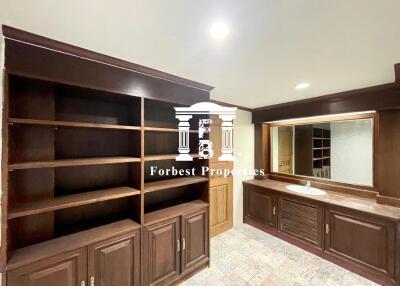 Bathroom with wooden cabinets and large mirror