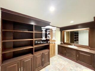 Bathroom with wooden cabinets and large mirror