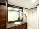 Modern bathroom with wooden cabinets and walk-in shower