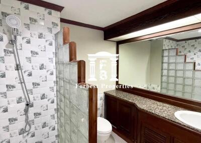 Bathroom with modern fixtures and wooden cabinetry