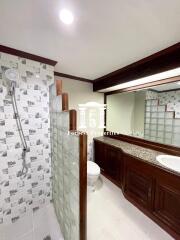 Bathroom with modern fixtures and wooden cabinetry