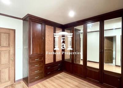 Bedroom with built-in wooden wardrobes and wooden flooring