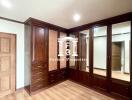 Bedroom with built-in wooden wardrobes and wooden flooring