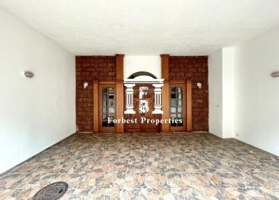 Main entryway with stone flooring and double wooden doors