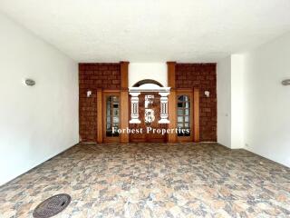 Main entryway with stone flooring and double wooden doors