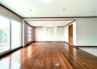 Spacious living room with hardwood flooring and large windows