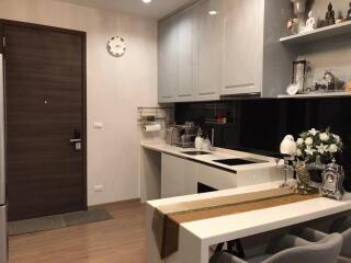 Modern kitchen with sleek cabinetry and small dining area