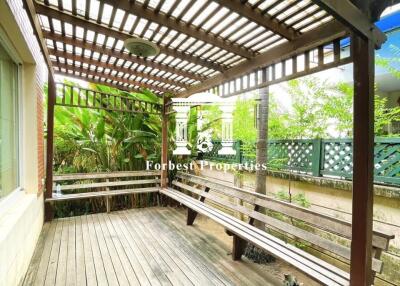 Outdoor patio with wooden deck and pergola