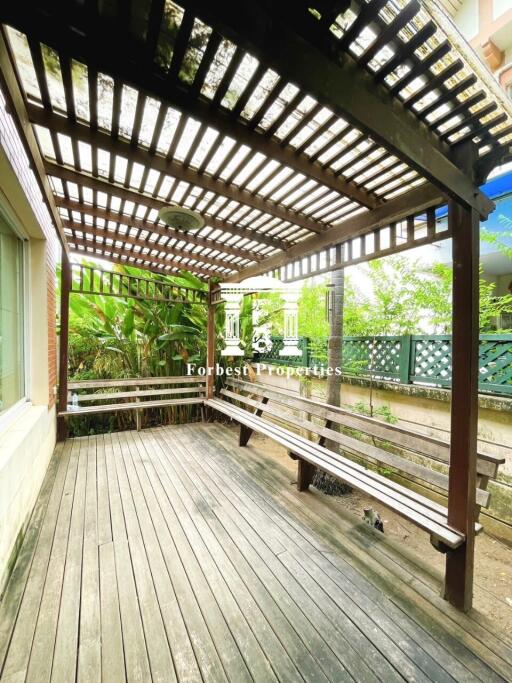 Outdoor patio with wooden deck and pergola