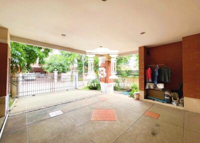 Spacious covered outdoor area with storage and view of lush greenery