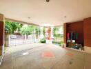 Spacious covered outdoor area with storage and view of lush greenery