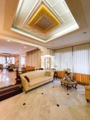 Spacious and elegantly designed living room with custom ceiling lighting