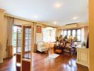 Spacious living room with wooden flooring and natural light