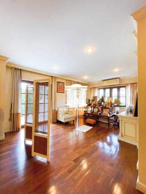 Spacious living room with wooden flooring and natural light