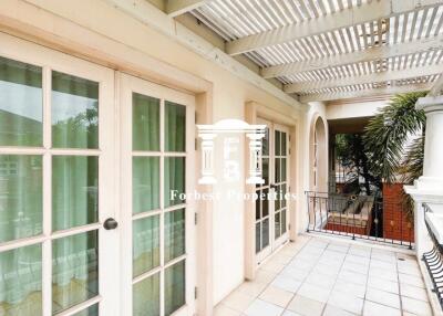 Open balcony area with glass doors and a pergola