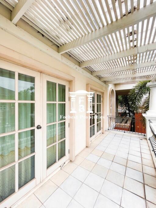 Open balcony area with glass doors and a pergola