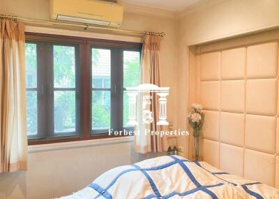 Bedroom with bed, window, and air conditioning unit