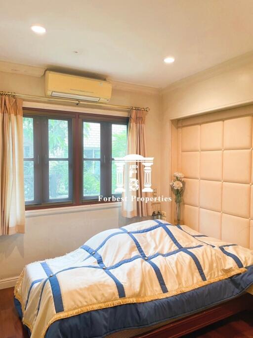 Bedroom with bed, window, and air conditioning unit