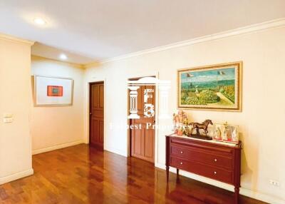 Spacious living room with wooden flooring and wall art