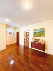 Spacious living room with wooden flooring and wall art