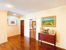 Spacious living room with wooden flooring and wall art