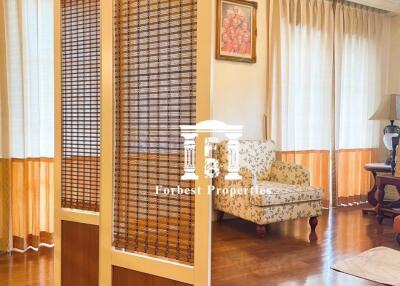 Cozy living room with wooden floor and decorative screen