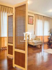 Cozy living room with wooden floor and decorative screen