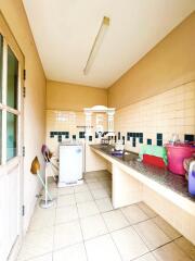 Simple kitchen with tiled countertops and backsplash