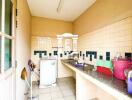 Simple kitchen with tiled countertops and backsplash