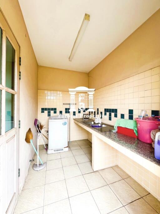 Simple kitchen with tiled countertops and backsplash