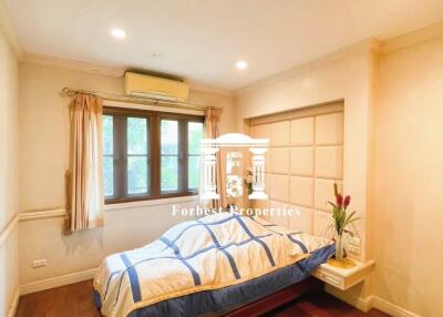 Cozy bedroom with hardwood floors and natural lighting