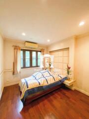 Cozy bedroom with hardwood floors and natural lighting