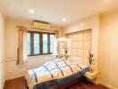 Cozy bedroom with hardwood floors and natural lighting