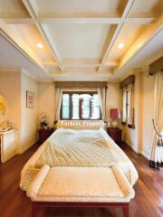 Comfortable and elegant bedroom with coffered ceiling