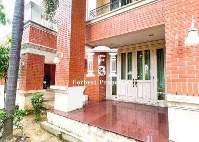 Bright and welcoming entrance of a residential building with red brick and white trims