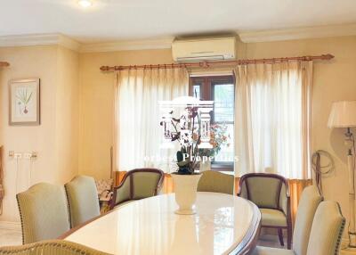 Elegant dining room with a polished wooden dining table and upholstered chairs