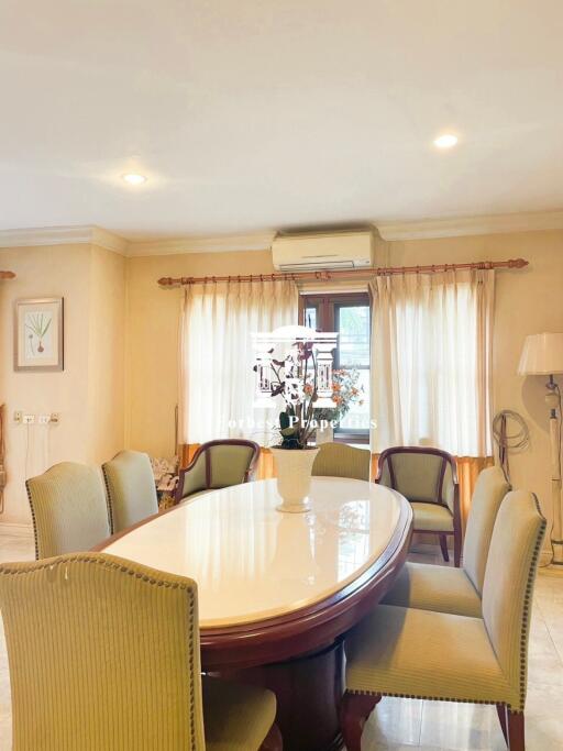 Elegant dining room with a polished wooden dining table and upholstered chairs