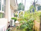 Outdoor walkway with greenery and air conditioning units