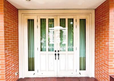 Front entrance with double doors and brick walls