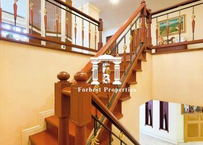 Elegant wooden staircase in a multi-story house with decorative railings