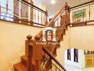 Elegant wooden staircase in a multi-story house with decorative railings