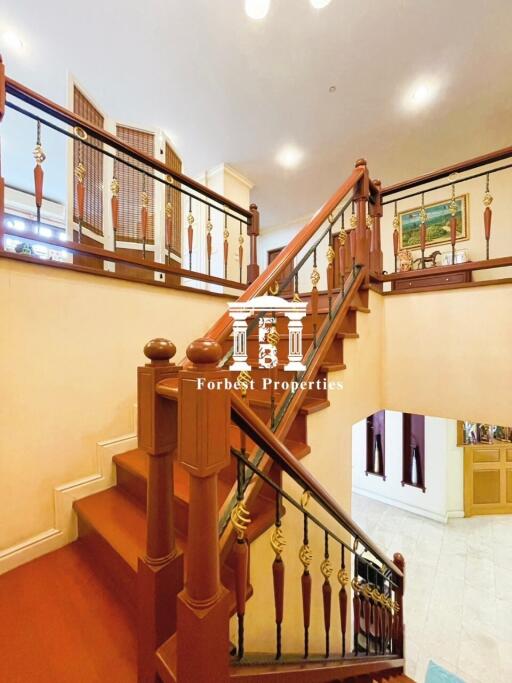 Elegant wooden staircase in a multi-story house with decorative railings