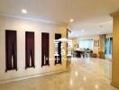 Spacious living area with marble flooring and decorative niches