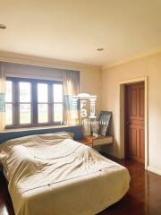 Bedroom with large window and wooden accents