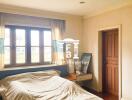 Bedroom with large window and wooden accents