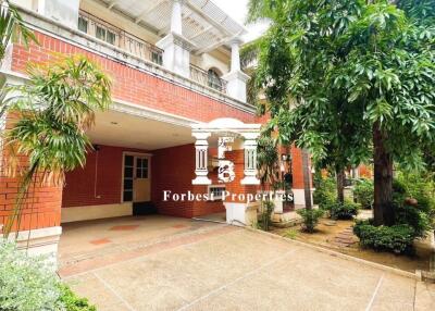 Front view of a two-story building surrounded by greenery