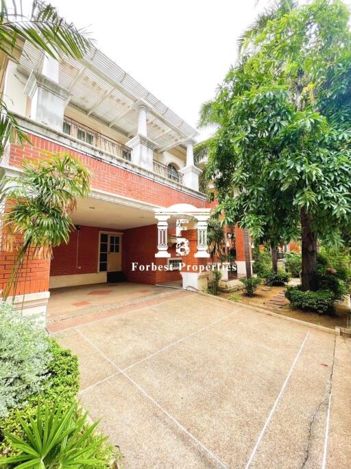 Front view of a two-story building surrounded by greenery