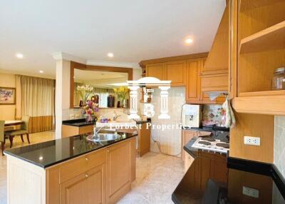 Modern kitchen with wooden cabinets and black countertops