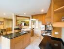 Modern kitchen with wooden cabinets and black countertops